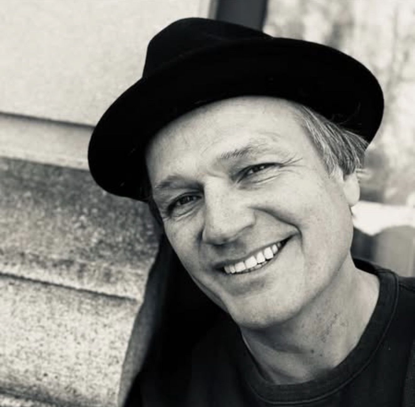 Timothy smiling in a black hat