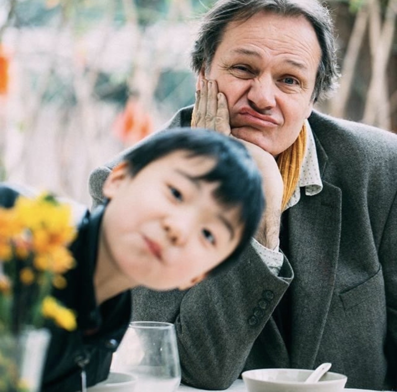 Timothy making a playful face with a child nearby